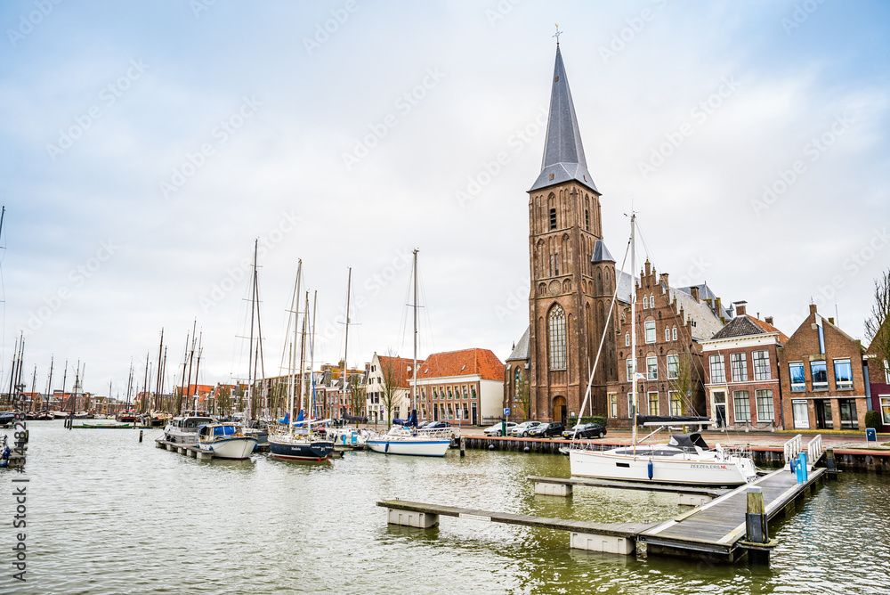Fototapeta premium January 10, 2020. H. Aartsengel Michael kerk - Church by the water canal in winter