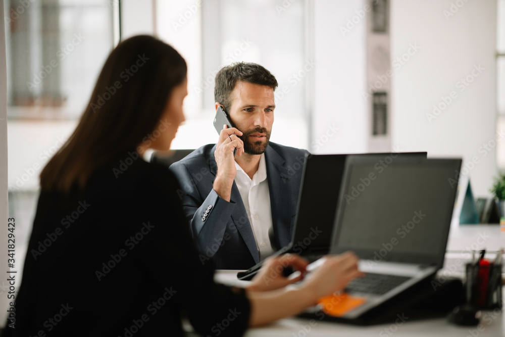 Businessman in office. Handsome man working on project. Businessman in office. Handsome man working on project.