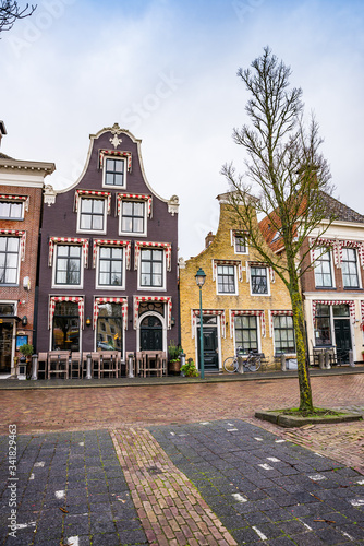 Harlingen, Netherlands - January 10, 2020. Zuiderhaven street in winter with traditional dutch houses