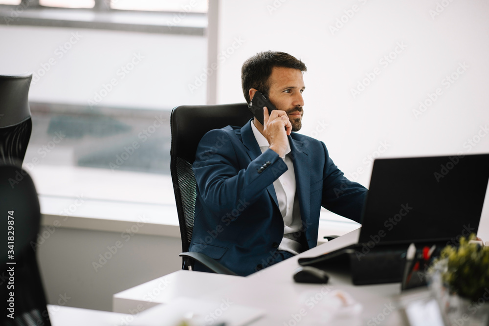 Businessman in office. Handsome man working on project. Businessman in office. Handsome man working on project.