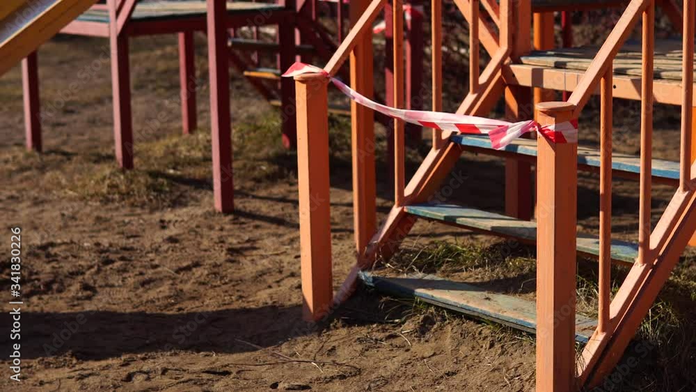 View of a closed playground. Children are also no longer allowed to enter the playgrounds. Playground locked down and closed during emergency COVID-19 restrictions. Ban on city play area. View of a closed playground. Children are also no longer allowed to enter the playgrounds. Playground locked down and closed during emergency COVID-19 restrictions. Ban on city play area.