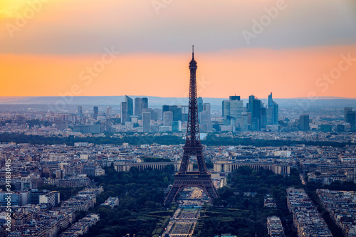 View of Paris with Eiffel Tower from Montparnasse building. Eiffel tower view from Montparnasse at sunset, view of the Eiffel Tower and La Defense district in Paris, France. © daliu