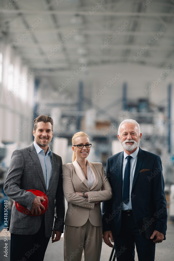 Colleagues working on project. Team of architects discussing business in factory. Colleagues working on project. Team of architects discussing business in factory.