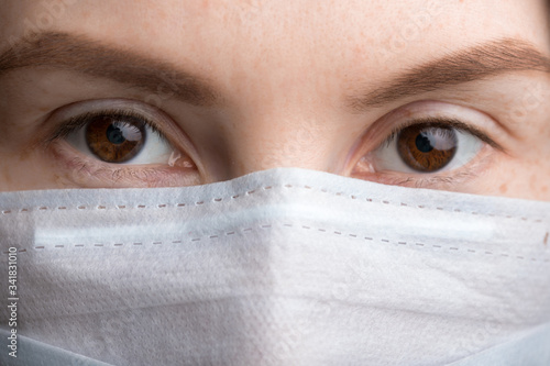 face of a girl in a medical mask close up