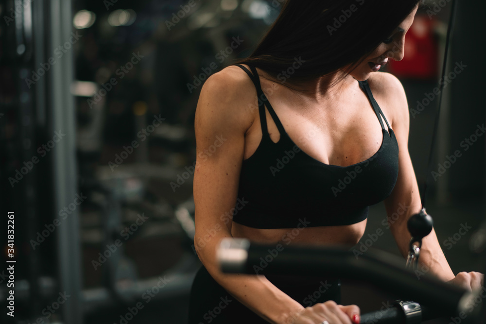 Fototapeta premium Fitness woman on training. Young woman in the gym. 