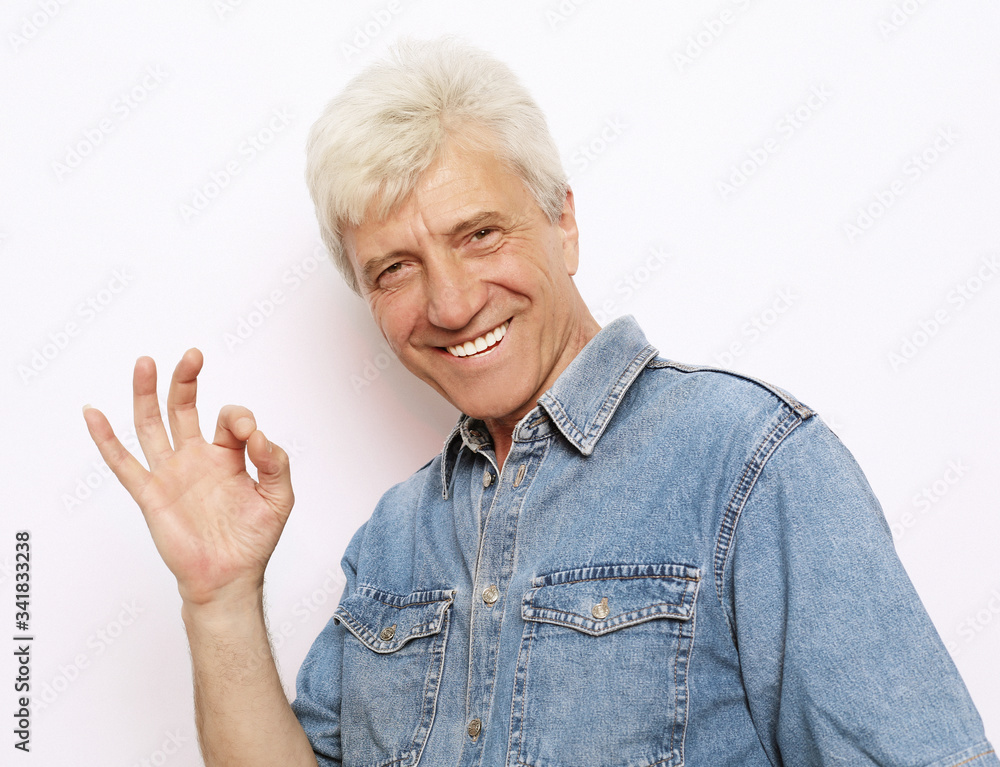lifestyle, emotion and people concept: Handsome mature man in casual wear is showing Ok sign lifestyle, emotion and people concept: Handsome mature man in casual wear is showing Ok sign