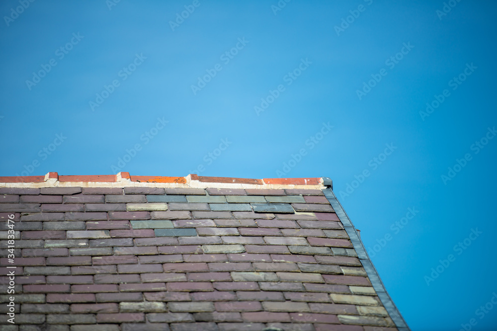Slate rooftop in a blue sky