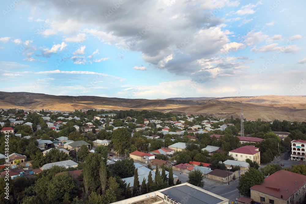 Wide angle panoramic view to Shemakhy city, Azerbaijan . View from above Shamakhi region . Clear view of the houses .