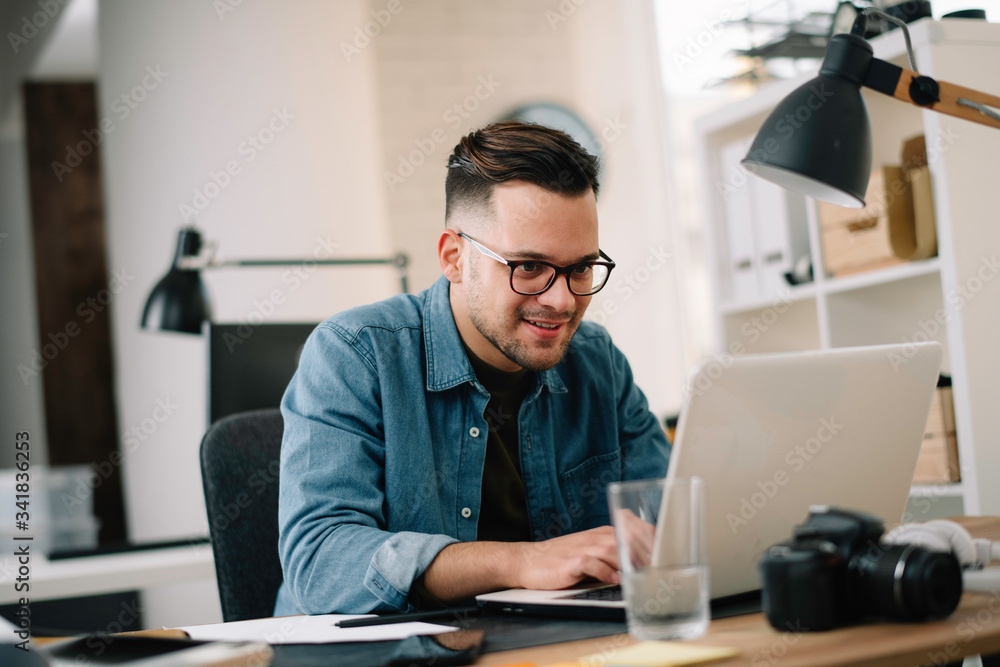 Businessman in office. Handsome man working on lap top. Businessman in office. Handsome man working on lap top.