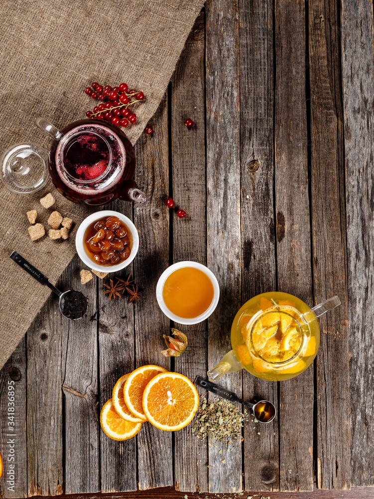 Authentic fruit tea with dried fruit in sweetened syrup. Red and yellow tea table nice presentation with white sugar cubes on a wooden table photography best use for magazine. Authentic fruit tea with dried fruit in sweetened syrup. Red and yellow tea table nice presentation with white sugar cubes on a wooden table photography best use for magazine.