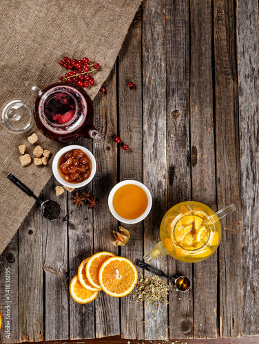 Authentic fruit tea with dried fruit in sweetened syrup. Red and yellow tea table nice presentation with white sugar cubes on a wooden table photography best use for magazine.