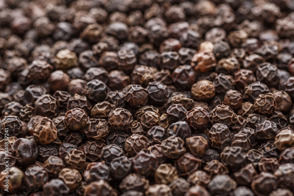 Peppercorn background. Dry black pepper seeds. Top view. Flat design. Macro spice background Peppercorn background. Dry black pepper seeds. Top view. Flat design. Macro spice background