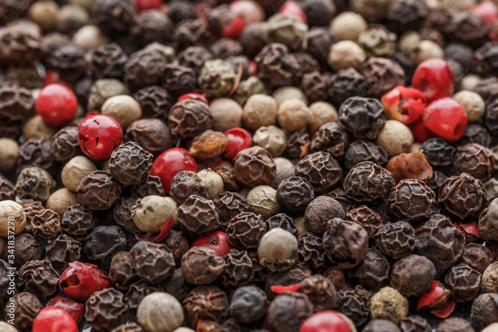 Close up of Mixted multi coloured peppercorns. white, black and green peppercorns macro background.Mixed peppercorns red black and white in bowl - Close-up. Close up of Mixted multi coloured peppercorns. white, black and green peppercorns macro background.Mixed peppercorns red black and white in bowl - Close-up.