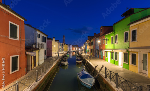 Street view with colorful buildings in Burano island  Venice  Italy. Architecture and landmarks of Burano  Venice postcard. Scenic canal and colorful architecture in Burano island near Venice  Italy