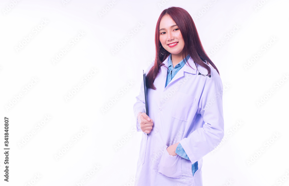 Cheerful young woman doctor in uniform with stethoscope holding clipboard isolated on white background. Smile female medical looking at camera while standing on white background. Healthy care concept.