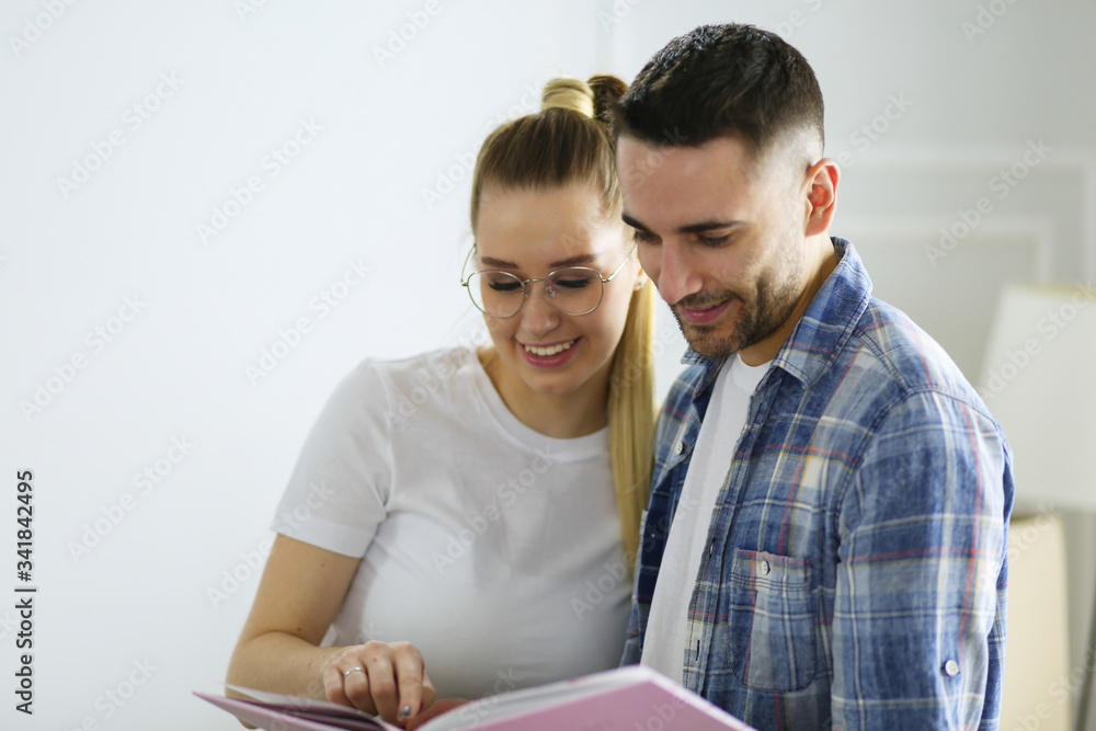 A just married couple unpacking boxes and moving into a new home. Positive emotion. A just married couple unpacking boxes and moving into a new home. Positive emotion.