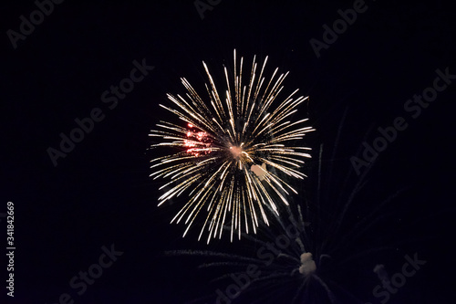 Festive salute in night sky. Explosions of fireworks and pyrotechnics in the sky.