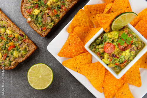 Bowl of fresh Guacamole with nachos chips. Healthy Vegan Concept.