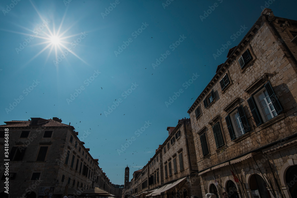 dubrovnik sky with sun and buildings