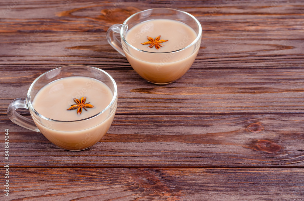 Glass cups of traditional indian tea masala tea on wooden background, rustic table. Glass cups of traditional indian tea masala tea on wooden background, rustic table.