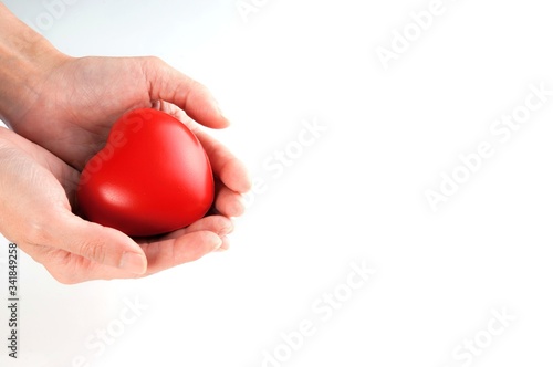 Woman hand holding red heart, health care, donate and family insurance concept, world heart day, world health day,CSR responsibility, adoption foster family, hope, gratitude, kind, concept