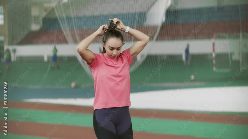 Young athlete woman collect hair in the tail before before sports exercise Young athlete woman collect hair in the tail before before sports exercise