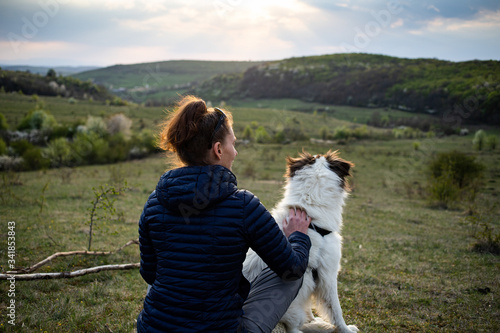 woman and dog enjoying outdoors on a green field © Melinda Nagy
