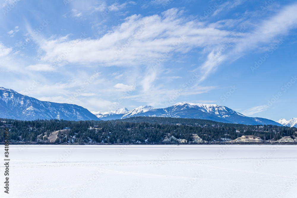 frozen Windermere lake and rocky mountains in british columbia canada.