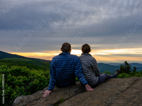 Print op canvas Couple Looks Out Over Sunset Falling on Blue Ridge