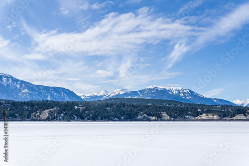 frozen Windermere lake and rocky mountains in british columbia canada. © olegmayorov