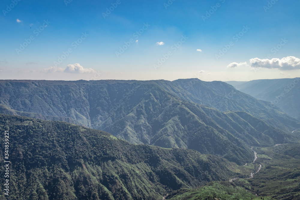 misty mountain range covered with white mist and amazing blue sky