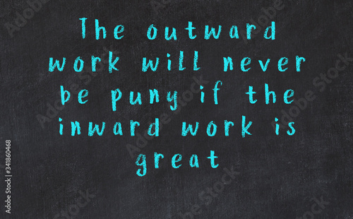 Chalk wise inscription on black chalkboard