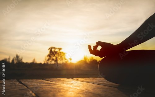 Close up hands. Woman do yoga relax outdoor. Woman exercising pose vital and meditation for fitness lifestyle at the outdoors nature background. Healthy and Yoga Concept.