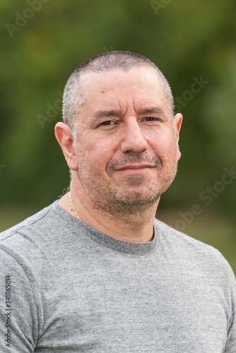 Portrait of a middle aged man with short hair, outdoor