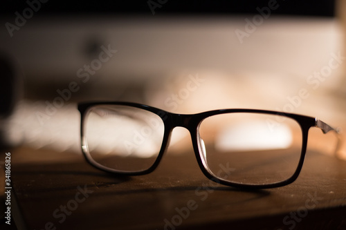 Glasses for sight and vision correction and protection from computer on the wooden table