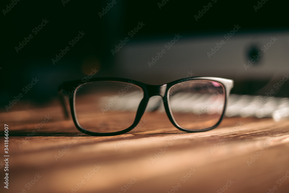 Glasses for sight and vision correction and protection from computer on the wooden table