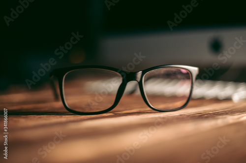 Glasses for sight and vision correction and protection from computer on the wooden table