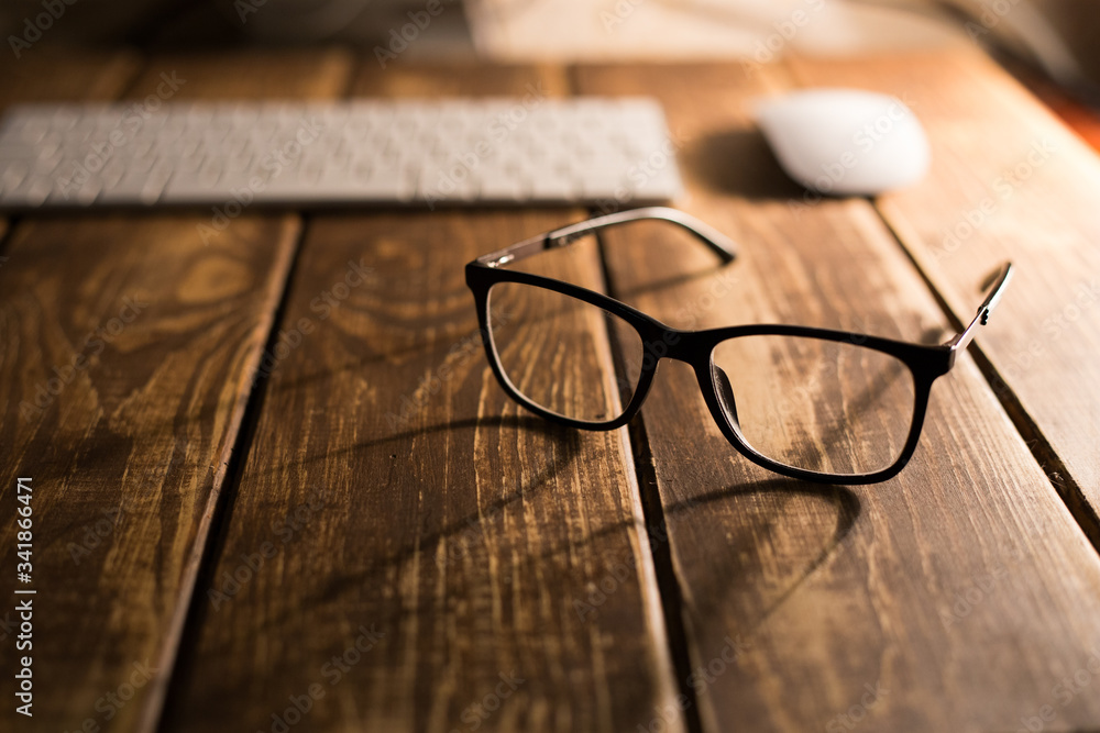 Glasses for sight and vision correction and protection from computer on the wooden table Glasses for sight and vision correction and protection from computer on the wooden table