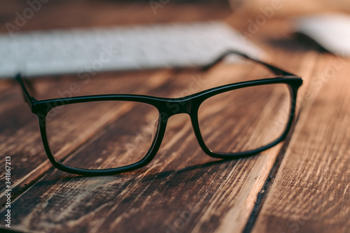 Glasses for sight and vision correction and protection from computer on the wooden table