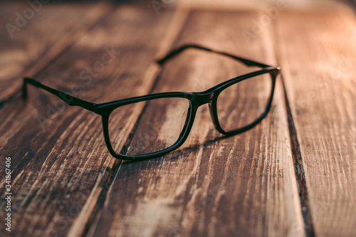 Glasses for sight and vision correction and protection from computer on the wooden table