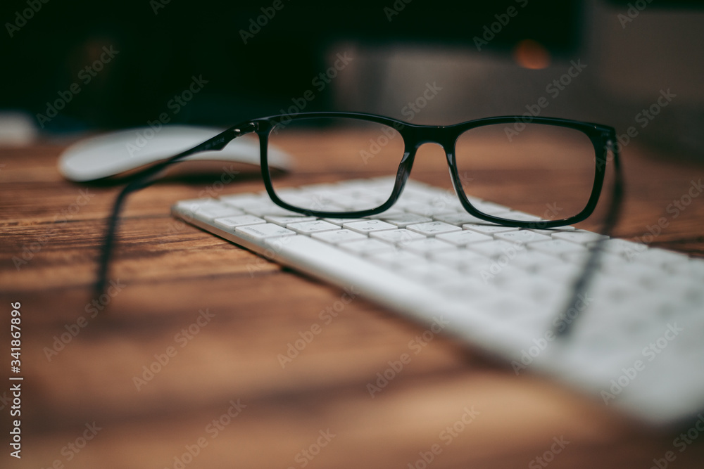 Glasses for sight and vision correction and protection from computer on the wooden table on the keyboard Glasses for sight and vision correction and protection from computer on the wooden table on the keyboard