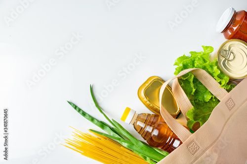 A bag of donated food. The concept of the delivery of necessary foodstuffs on a white background.