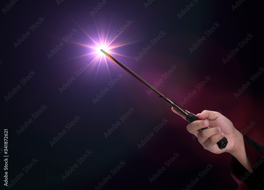 Magic wand on mysterious background, Miracle magical stick Wizard tool on  black Photos | Adobe Stock