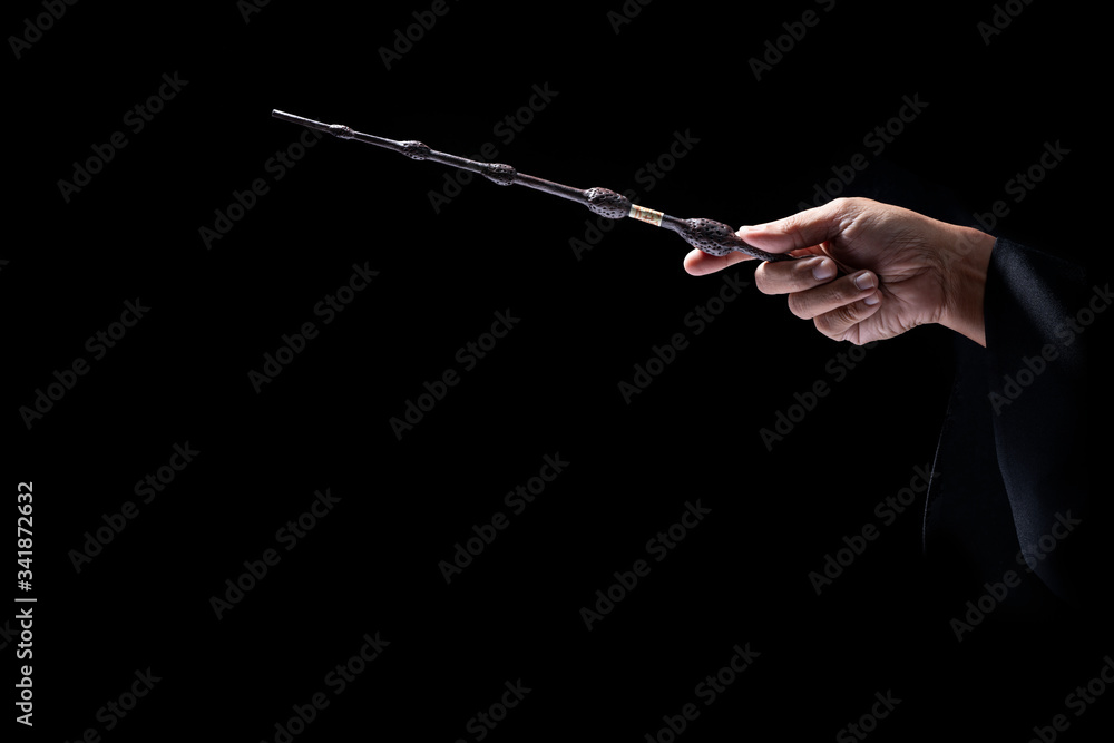 Obraz premium Magic wand on mysterious background, Miracle magical stick Wizard tool on black