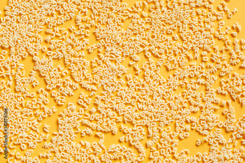 Macaroni Alphabet. A set of ingredients, raw macaroni in the form of letters.   Food background