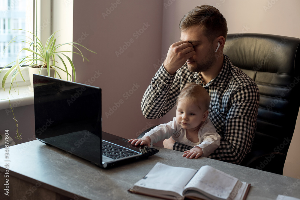 Young sad depressed working father work at home office while babysitting  his playful baby daughter at  emotion concept Stock Photo |  Adobe Stock