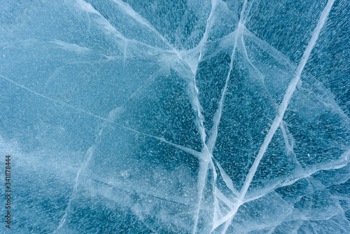 Beautiful ice of Lake Baikal with abstract cracks photo