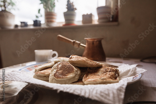 freshly baked pancakes in plate on table. Tasty morning breakfast with hot flapjacks and coffee. homemade delicious fried pancakes. Selective focus