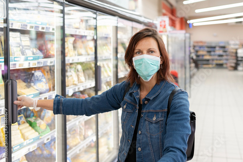 Woman wearing mask shopping in supermarket