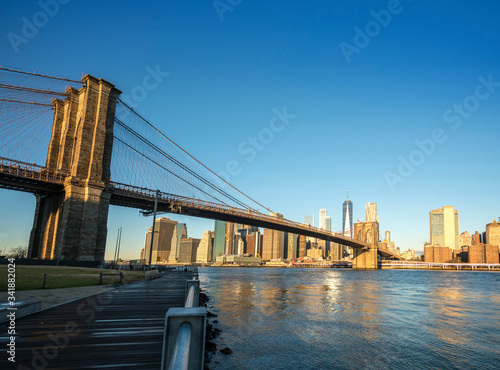 Famous Skyline of downtown New York, Brooklyn Bridge and Manhattan at the early morning sun light , New York City USA .